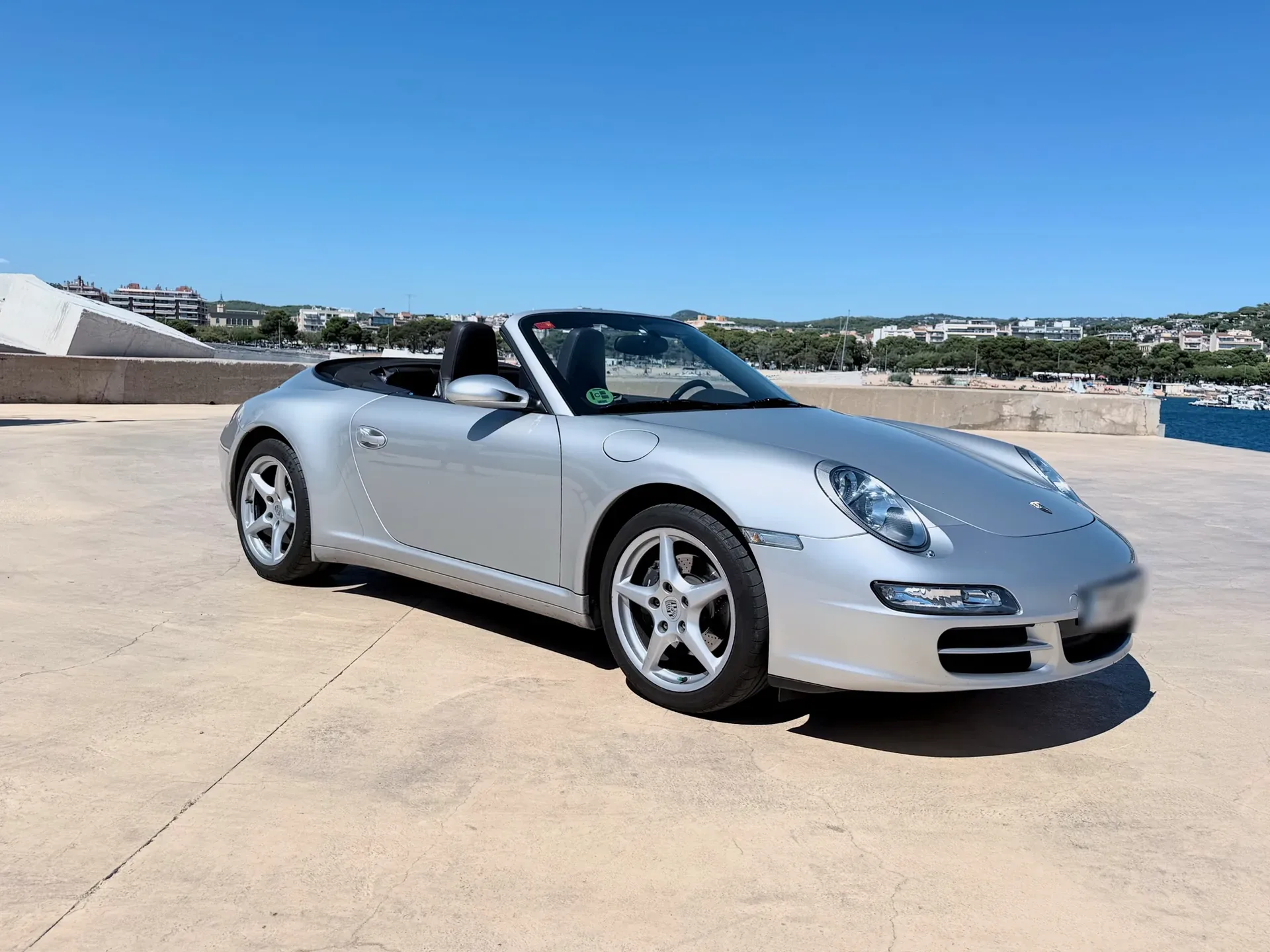 Complete Porsche 911 Carrera 4 Cabriolet in a front three-quarter view with the roof down